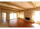 Hardwood floors complement the stone fireplace and bright windows in this inviting living room at 219 W Denton Ln, Phoenix, AZ 85013