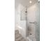 Walk-in shower with marble tiling, glass enclosure and rainfall showerhead at 21901 N Sonora Ln, Sun City West, AZ 85375