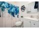Bathroom with a blue shower curtain, hexagon wall decoration, and white cabinets at 21901 N Sonora Ln, Sun City West, AZ 85375