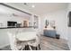 Stylish dining area featuring modern furnishings and wood flooring at 21901 N Sonora Ln, Sun City West, AZ 85375
