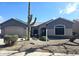 Lovely home featuring desert landscaping, mature trees, and a tidy front yard at 21901 N Sonora Ln, Sun City West, AZ 85375