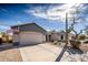 Single-Gathering home boasts a tidy front yard, desert landscaping, and an attached garage at 21901 N Sonora Ln, Sun City West, AZ 85375