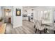 Bright kitchen with stainless steel appliances, white cabinets, and wood flooring at 21901 N Sonora Ln, Sun City West, AZ 85375