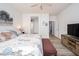 Bedroom with bright natural light, ceiling fan, wood flooring and floral comforter at 21901 N Sonora Ln, Sun City West, AZ 85375