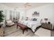 Bedroom with bright natural light, ceiling fan, wood flooring and floral comforter at 21901 N Sonora Ln, Sun City West, AZ 85375