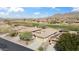 Breathtaking aerial view of a residential area showcasing well-maintained homes and vibrant green spaces at 2214 W Muirfield Dr, Anthem, AZ 85086