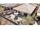 Aerial view of an outdoor area featuring a BBQ, dining area, a fire pit, and lounge chairs at 2214 W Muirfield Dr, Anthem, AZ 85086