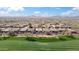 Scenic community view of the property with surrounding homes and desert landscape under a blue sky at 2214 W Muirfield Dr, Anthem, AZ 85086