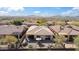 Aerial view of a property highlights a private backyard and desert landscape at 2214 W Muirfield Dr, Anthem, AZ 85086