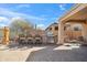 Desert backyard featuring a built-in BBQ, bar seating, lounge area and desert views at 2214 W Muirfield Dr, Anthem, AZ 85086