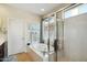 Bright bathroom featuring a soaking tub, separate shower, and natural light at 2214 W Muirfield Dr, Anthem, AZ 85086