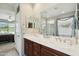 Bathroom featuring a double sink vanity, large mirror, and enclosed shower at 2214 W Muirfield Dr, Anthem, AZ 85086