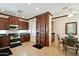 Spacious kitchen with dark wood cabinetry, stainless steel appliances, and sleek black countertops at 2214 W Muirfield Dr, Anthem, AZ 85086