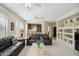 Inviting living room featuring comfortable seating, neutral tones, and seamless flow into the kitchen area at 2214 W Muirfield Dr, Anthem, AZ 85086