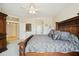 Spacious bedroom with decorative headboard, bedside tables, and ensuite bathroom access at 2214 W Muirfield Dr, Anthem, AZ 85086