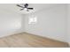 Simple bedroom with laminate flooring, a modern ceiling fan, neutral walls, and a window at 2244 E Janice Way, Phoenix, AZ 85022