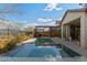 Spacious backyard featuring a pool, spa, outdoor grill and relaxing pergola at 2423 N Beverly Pl, Buckeye, AZ 85396