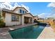Backyard with a pool, covered patio and luscious landscaping at 2423 N Beverly Pl, Buckeye, AZ 85396