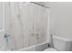 Bright bathroom featuring a shower with a white shower curtain, white toilet and chrome fixtures at 2423 N Beverly Pl, Buckeye, AZ 85396