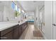 Bright bathroom with dual sinks, quartz countertop, and glass walk-in shower at 2423 N Beverly Pl, Buckeye, AZ 85396