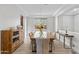 Elegant dining room with a large glass table, seating for ten, and tray ceilings at 2423 N Beverly Pl, Buckeye, AZ 85396