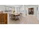 Elegant dining room featuring a large glass table with seating and modern lighting at 2423 N Beverly Pl, Buckeye, AZ 85396