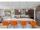 Modern kitchen featuring an island with seating, pendant lighting and stainless steel appliances at 2423 N Beverly Pl, Buckeye, AZ 85396