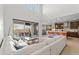 Open floor plan showcasing living room and kitchen with seamless indoor-outdoor flow to the pool at 2423 N Beverly Pl, Buckeye, AZ 85396