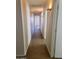 Bright hallway illuminated by sconces, showcasing the architecture and flow of the home's interior at 24930 W Dove Mesa Dr, Buckeye, AZ 85326