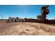 Open backyard with gravel, palm trees, and partial fencing, showing house exterior at 2502 W Jefferson St, Phoenix, AZ 85009