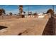 Large, gravel-covered backyard with mature trees and a wooden fence at 2502 W Jefferson St, Phoenix, AZ 85009