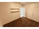 Carpeted bedroom with neutral walls and shelves at 2502 W Jefferson St, Phoenix, AZ 85009