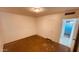 Spacious bedroom with neutral walls, closet, and doorway to the bathroom at 2502 W Jefferson St, Phoenix, AZ 85009