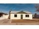 Charming single-story home featuring a white facade, symmetrical windows, and a secure front door at 2502 W Jefferson St, Phoenix, AZ 85009