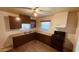Kitchen with brown cabinets, laminate countertop, plank flooring, and black appliances at 2502 W Jefferson St, Phoenix, AZ 85009