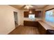 Functional kitchen with brown cabinets, laminate countertops, and plank flooring at 2502 W Jefferson St, Phoenix, AZ 85009