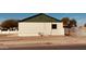 Side view of the residence showcases a white brick exterior, accented by a green trim along the roofline at 2502 W Jefferson St, Phoenix, AZ 85009