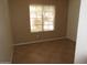 Bedroom with neutral paint, tile floor, and large window at 2637 S 156Th Ave, Goodyear, AZ 85338