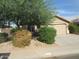 Beige single-story home with well-kept landscaping and a two-car garage at 2637 S 156Th Ave, Goodyear, AZ 85338