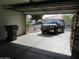 View of the garage with a car and trash bin at 2637 S 156Th Ave, Goodyear, AZ 85338