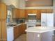 Bright kitchen with white appliances, oak cabinets, and tile flooring at 2637 S 156Th Ave, Goodyear, AZ 85338