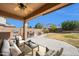 Spacious backyard with a covered patio, outdoor seating, a built-in grill, and a fire pit at 2987 E Powell Way, Gilbert, AZ 85298