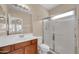 Bathroom with wood vanity and shower with glass door at 2987 E Powell Way, Gilbert, AZ 85298