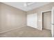 Bedroom featuring carpet, ceiling fan, and double-door closet at 2987 E Powell Way, Gilbert, AZ 85298