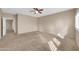 Bright bedroom featuring neutral walls, plush carpet, ceiling fan, and shuttered windows at 2987 E Powell Way, Gilbert, AZ 85298