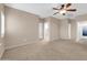 Large bedroom with neutral carpet, ceiling fan, and bright windows at 2987 E Powell Way, Gilbert, AZ 85298