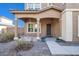 Close-up of the front porch with a path leading to the front door framed by columns and flower pots at 2987 E Powell Way, Gilbert, AZ 85298