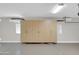 Well-lit garage featuring ample storage cabinets, perfect for organization and keeping your space tidy at 2987 E Powell Way, Gilbert, AZ 85298