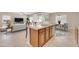 Open kitchen features a central island, views into the living room and dining areas, and modern appliances at 2987 E Powell Way, Gilbert, AZ 85298