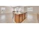 Kitchen island with double sink, granite countertops, seating, and stainless dishwasher, looking out to living area at 2987 E Powell Way, Gilbert, AZ 85298